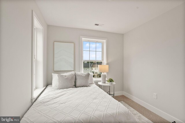 bedroom featuring carpet flooring, baseboards, and visible vents