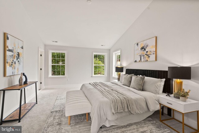 bedroom with visible vents, baseboards, carpet flooring, and vaulted ceiling