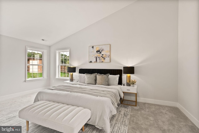 bedroom featuring baseboards, carpet floors, visible vents, and vaulted ceiling