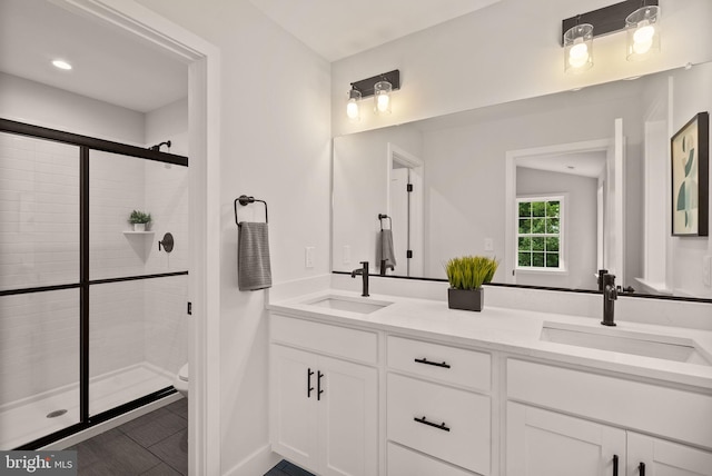 bathroom featuring walk in shower, vanity, tile patterned flooring, and toilet