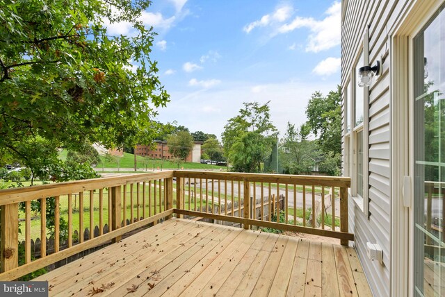 wooden deck featuring a yard