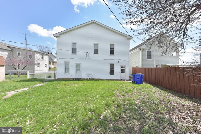 rear view of house with a yard