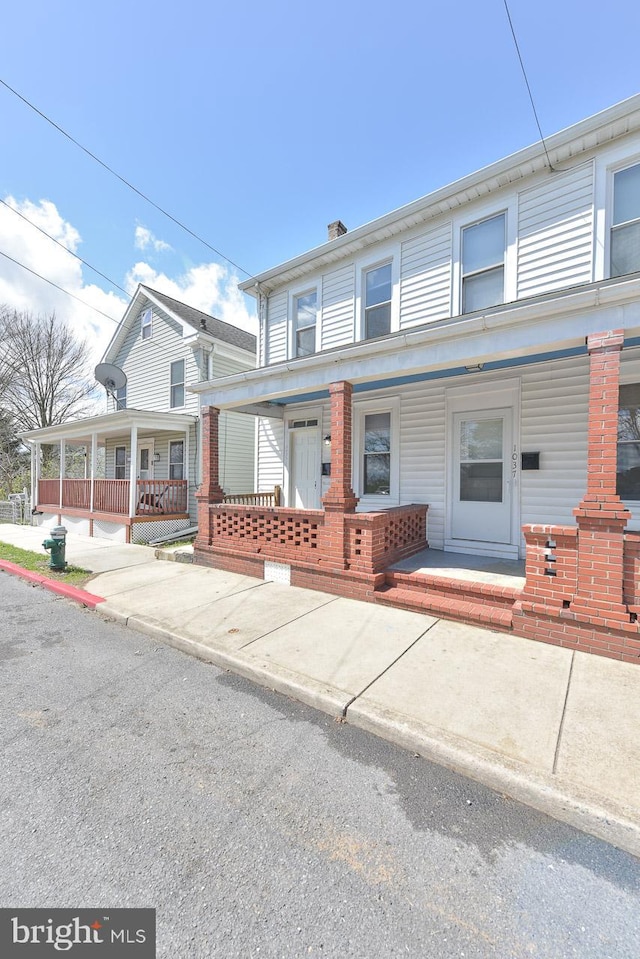 townhome / multi-family property featuring a porch