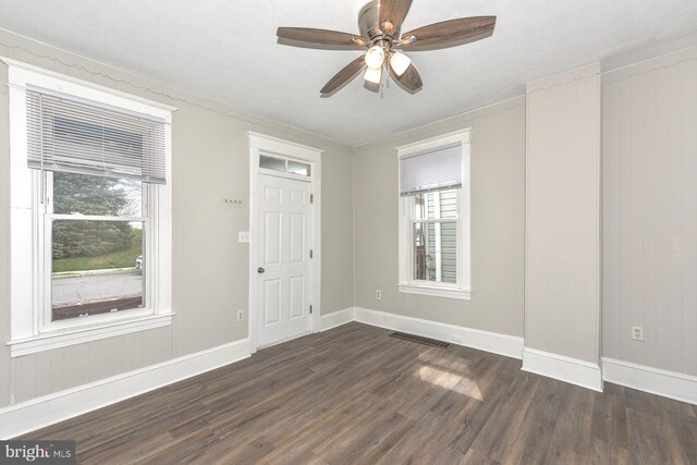 empty room with ceiling fan and dark hardwood / wood-style floors