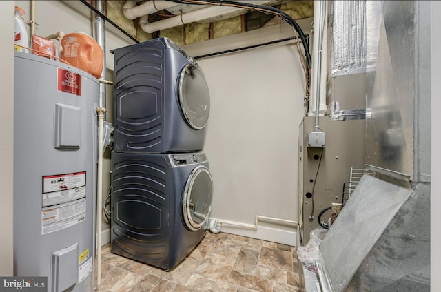 washroom featuring electric water heater and stacked washer / dryer