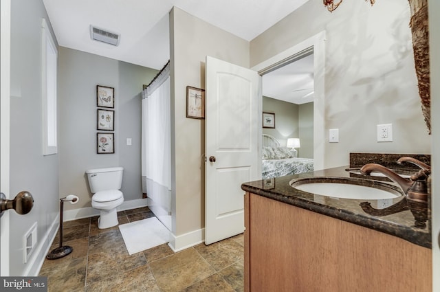 bathroom featuring vanity, toilet, and a shower with curtain