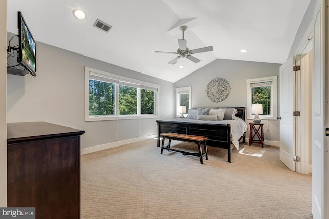 carpeted bedroom with multiple windows, vaulted ceiling, and ceiling fan