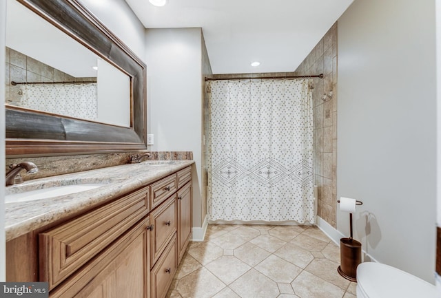 bathroom featuring vanity, toilet, a shower with curtain, and tile patterned floors