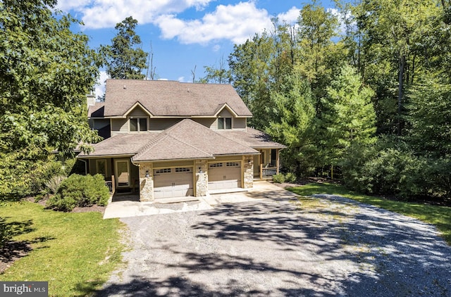 view of front of property with a garage and a front lawn