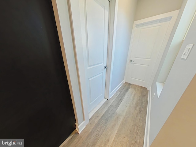 hallway with light hardwood / wood-style floors