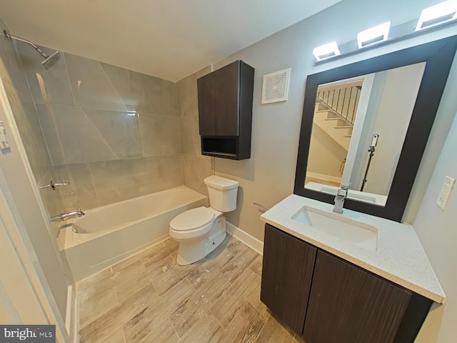 full bathroom with vanity, toilet, hardwood / wood-style floors, and tiled shower / bath