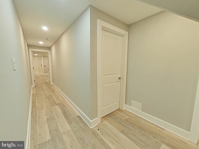 corridor with light hardwood / wood-style flooring