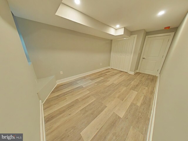 basement featuring light hardwood / wood-style flooring