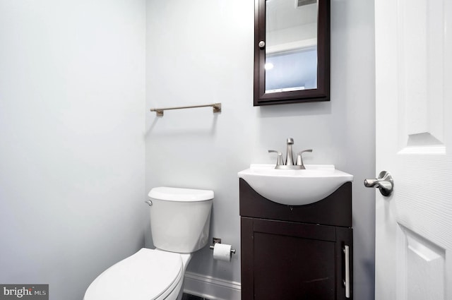 bathroom featuring toilet and vanity