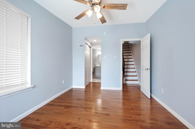 unfurnished bedroom with ceiling fan and dark hardwood / wood-style floors