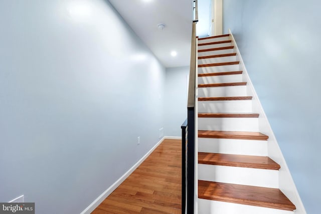 stairs with wood-type flooring