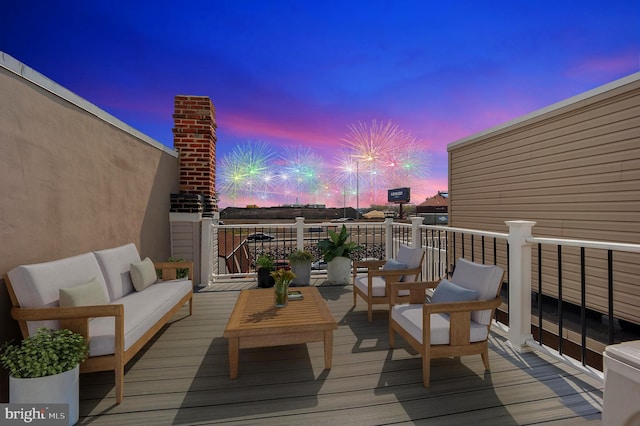 deck at dusk with an outdoor hangout area