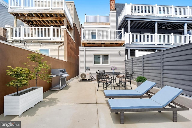 view of patio with a balcony, ac unit, and area for grilling