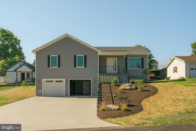 view of front of property with a front yard and a garage