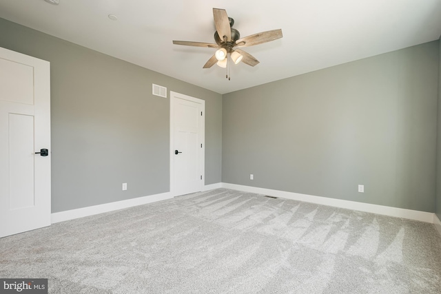 carpeted empty room with ceiling fan