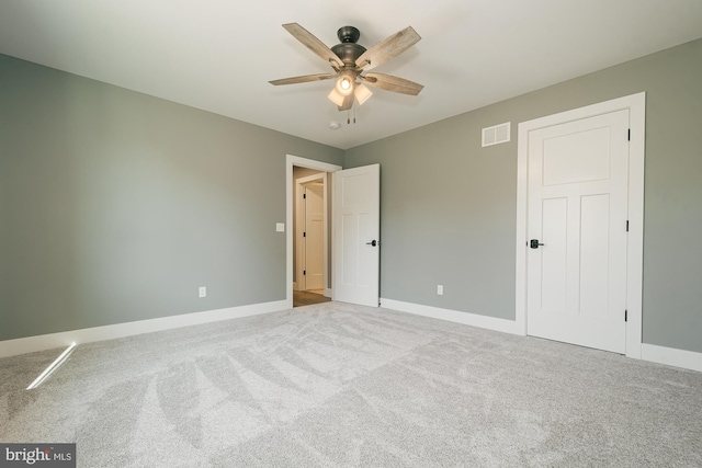 unfurnished bedroom with ceiling fan and light carpet