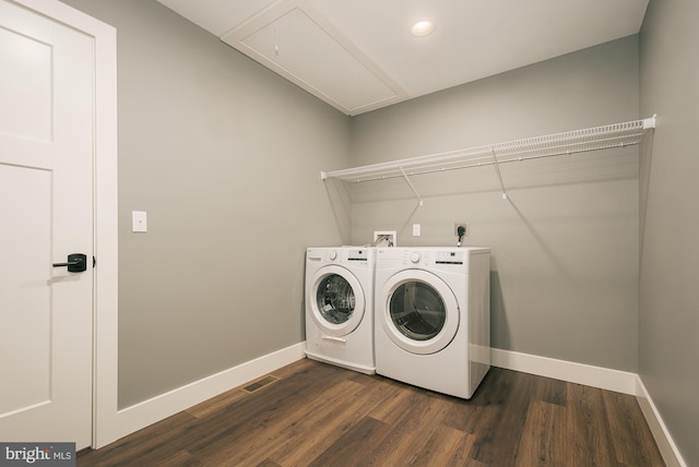 laundry area featuring dark hardwood / wood-style flooring and washing machine and clothes dryer