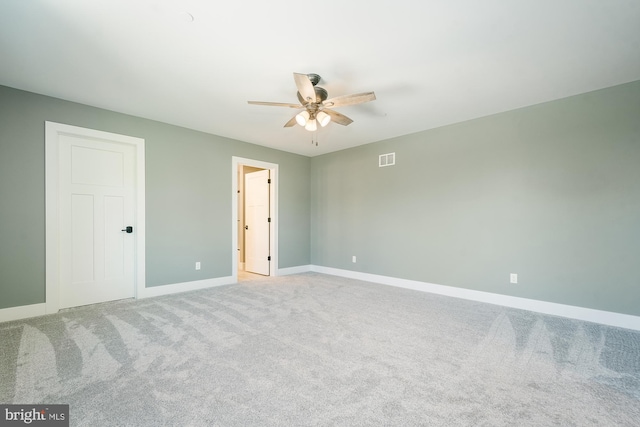 carpeted spare room featuring ceiling fan