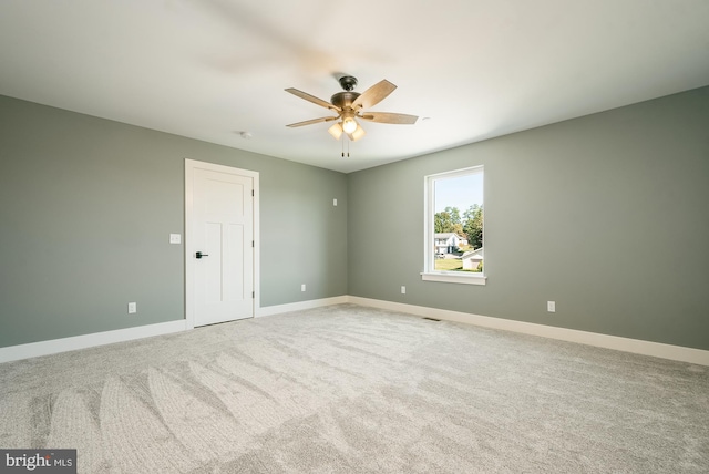 carpeted empty room with ceiling fan