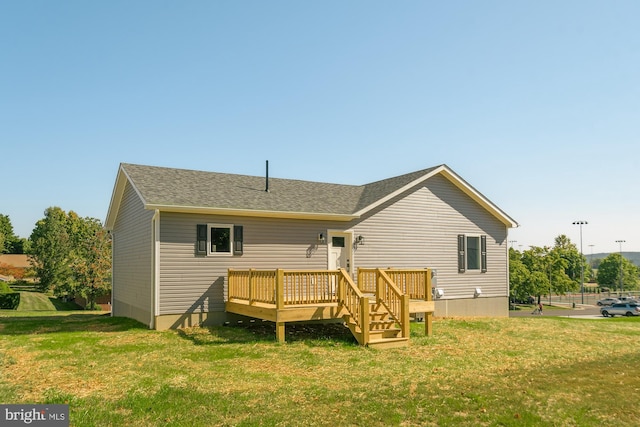 back of property featuring a yard and a deck