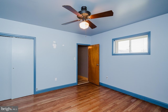 unfurnished bedroom with ceiling fan, light hardwood / wood-style floors, and a closet