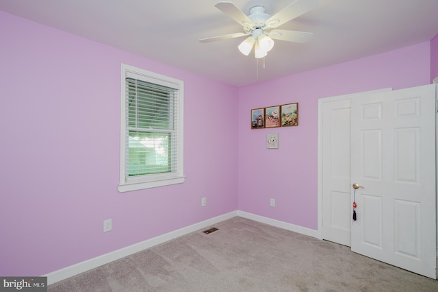 unfurnished bedroom with ceiling fan and light colored carpet