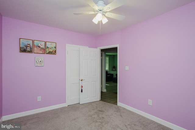 unfurnished bedroom featuring ceiling fan and light carpet