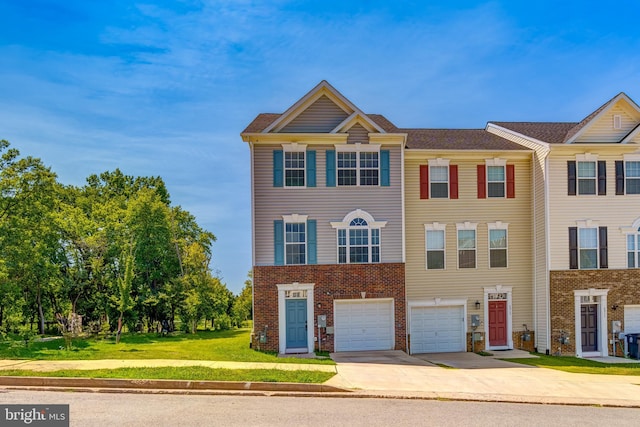 multi unit property with a garage and a front lawn