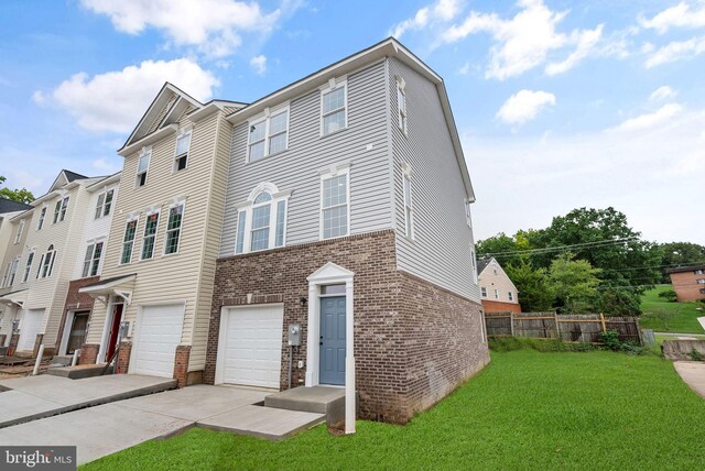 multi unit property with a garage and a front yard