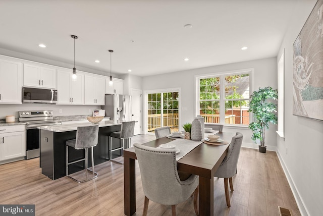 dining area with light hardwood / wood-style flooring