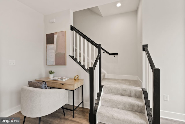 stairway with hardwood / wood-style flooring