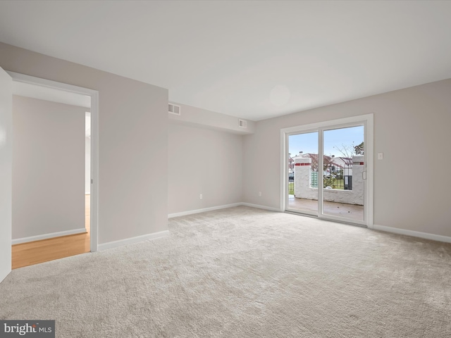 empty room featuring light colored carpet