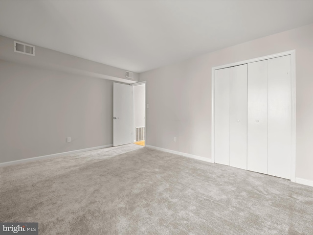 unfurnished bedroom featuring a closet and carpet