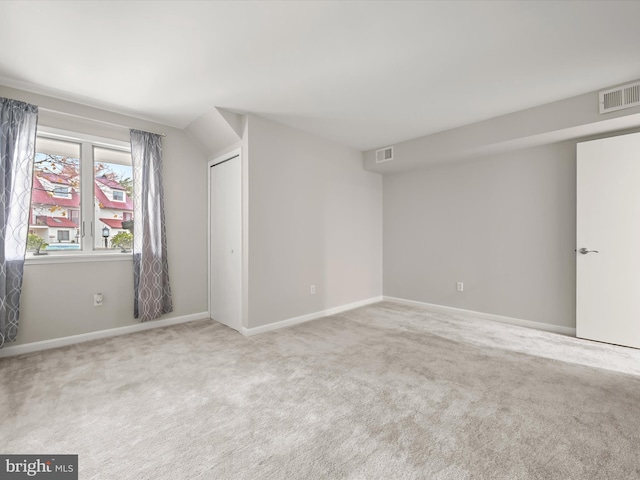 unfurnished room featuring light colored carpet