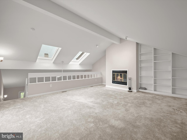 bonus room featuring carpet flooring and lofted ceiling with skylight