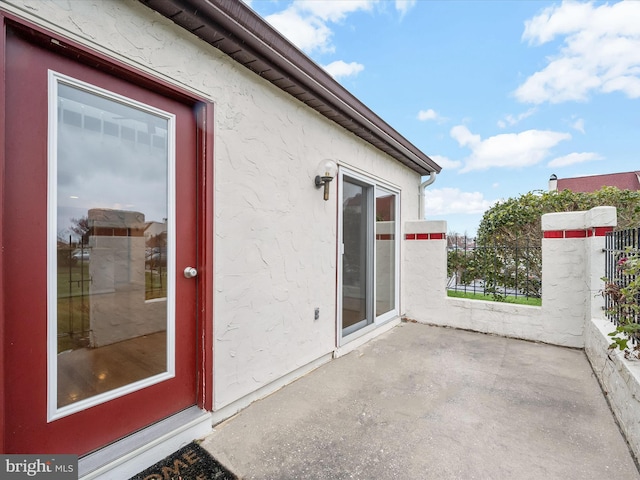 view of exterior entry featuring a patio area