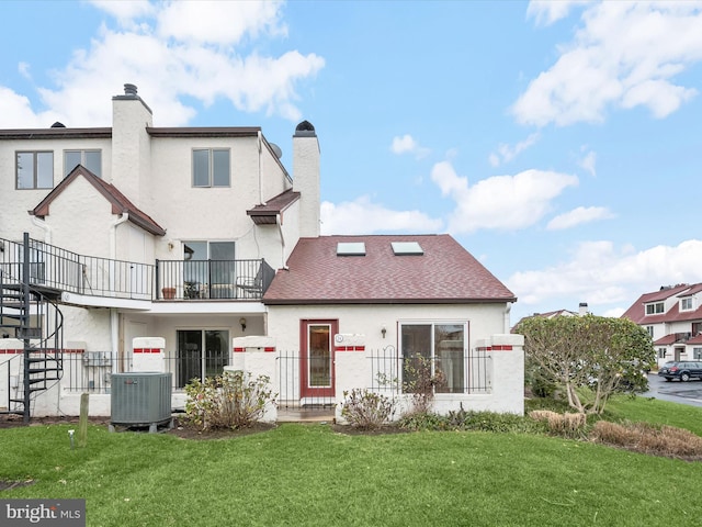 back of property featuring a yard and central air condition unit