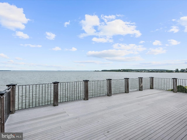 wooden terrace featuring a water view