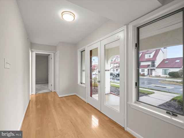 entryway featuring light hardwood / wood-style floors and french doors