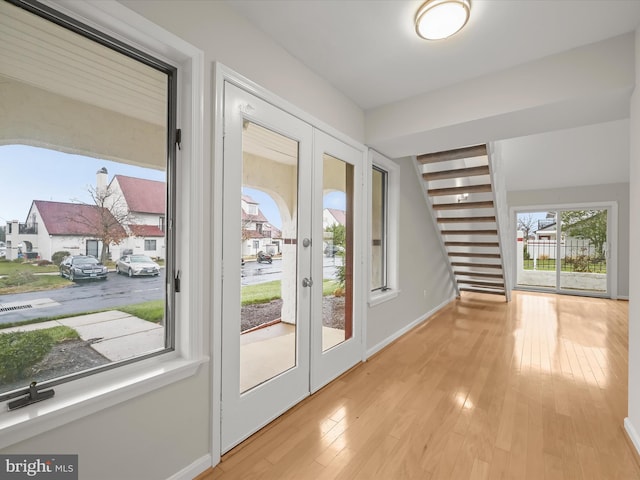 doorway to outside featuring light wood-type flooring and french doors