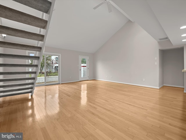 unfurnished living room with ceiling fan, high vaulted ceiling, and light hardwood / wood-style floors