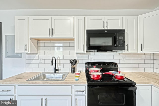 kitchen with decorative backsplash, white cabinets, black appliances, and sink