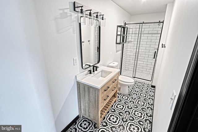 bathroom with tile patterned flooring, vanity, toilet, and a shower with door