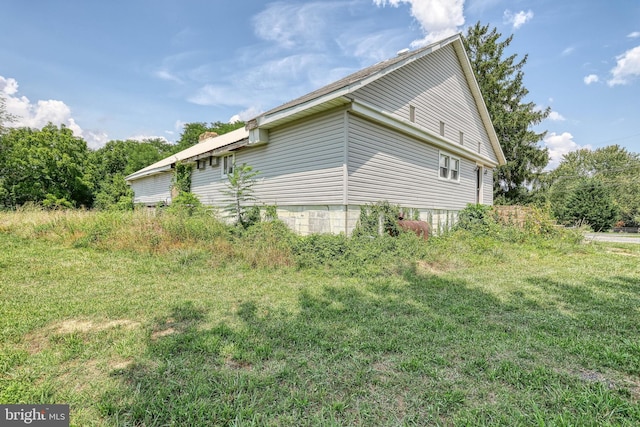 view of property exterior with a lawn