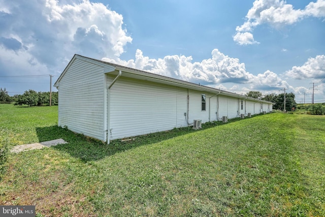 view of home's exterior with a yard and central air condition unit